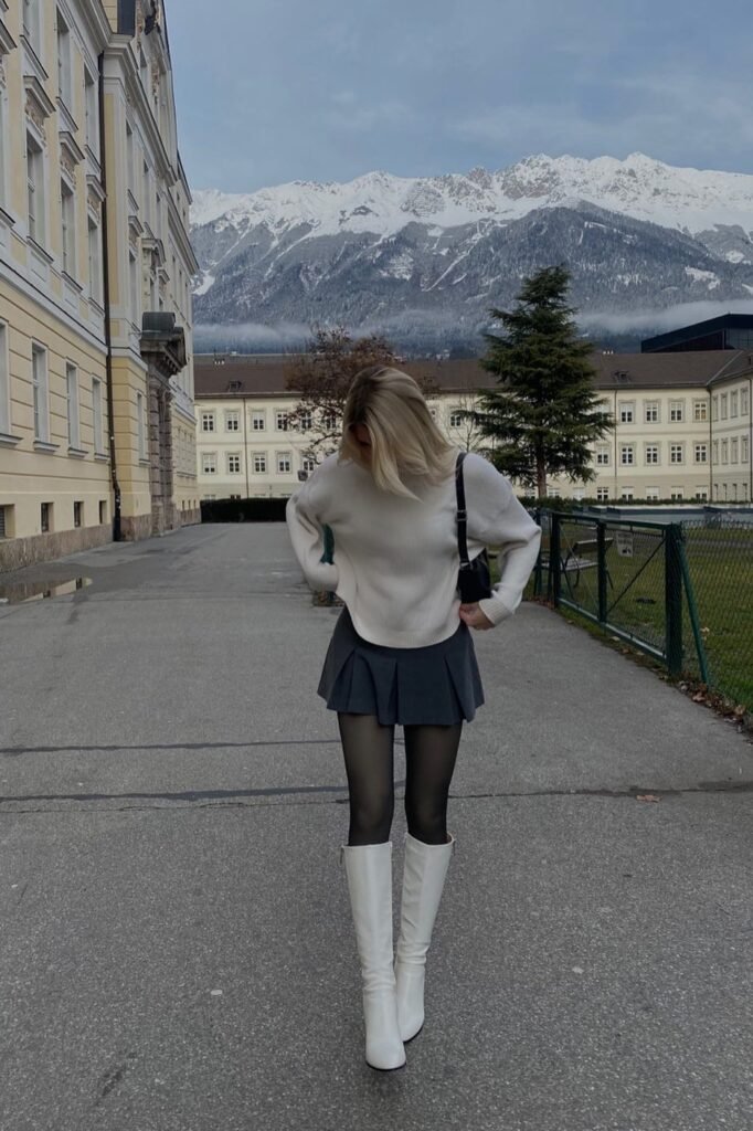Cream Oversized Sweater + Grey Pleated Mini Skirt + White Knee-High Boots