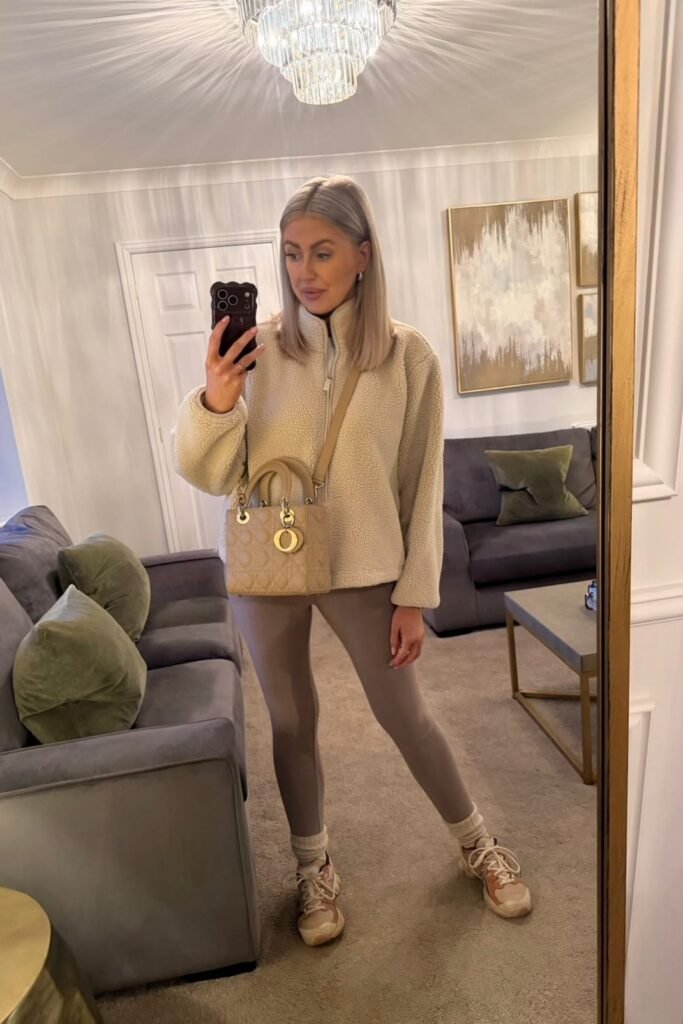 Cream Sherpa Zip-up Jacket + Taupe Leggings + Beige Designer Crossbody Bag + Tan Athletic Sneakers