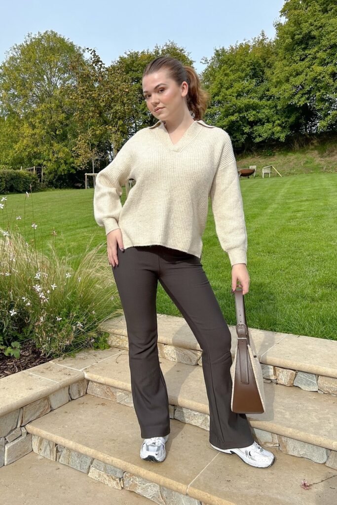 Cream V-Neck Ribbed Sweater + Dark Brown Flared Trousers + White Athletic Sneakers