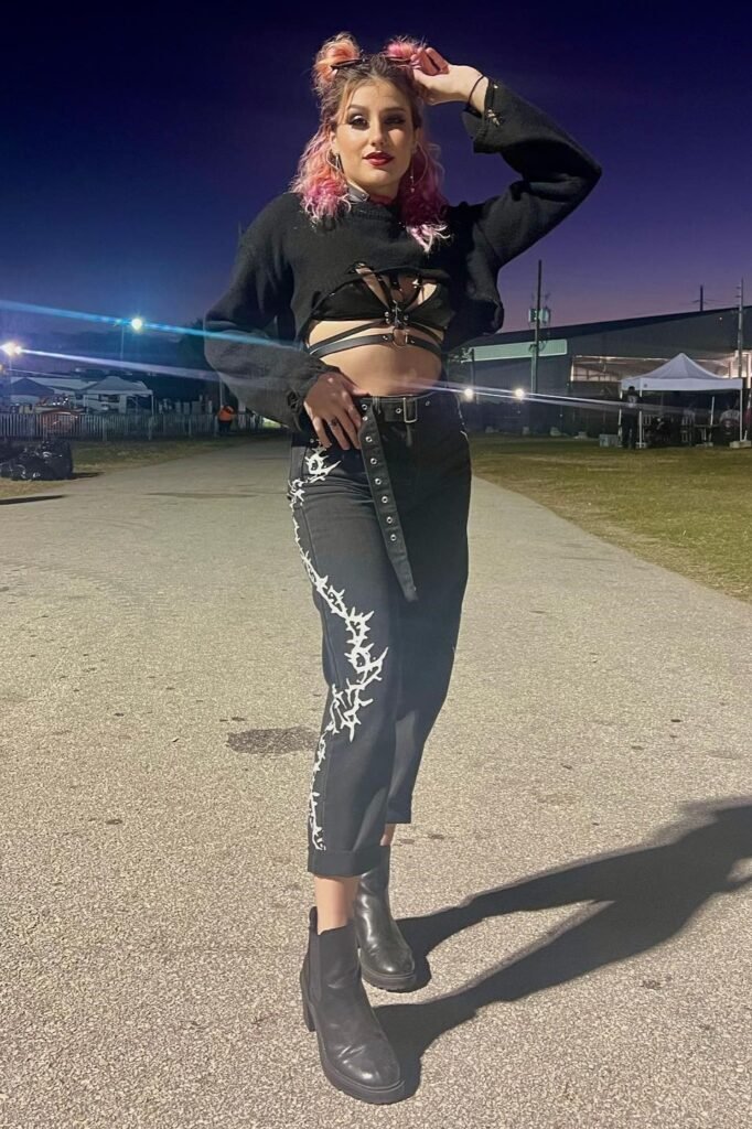 Cropped Black Shrug over Strappy Harness Top + Barbed Wire Print Jeans + Black Chelsea Boots