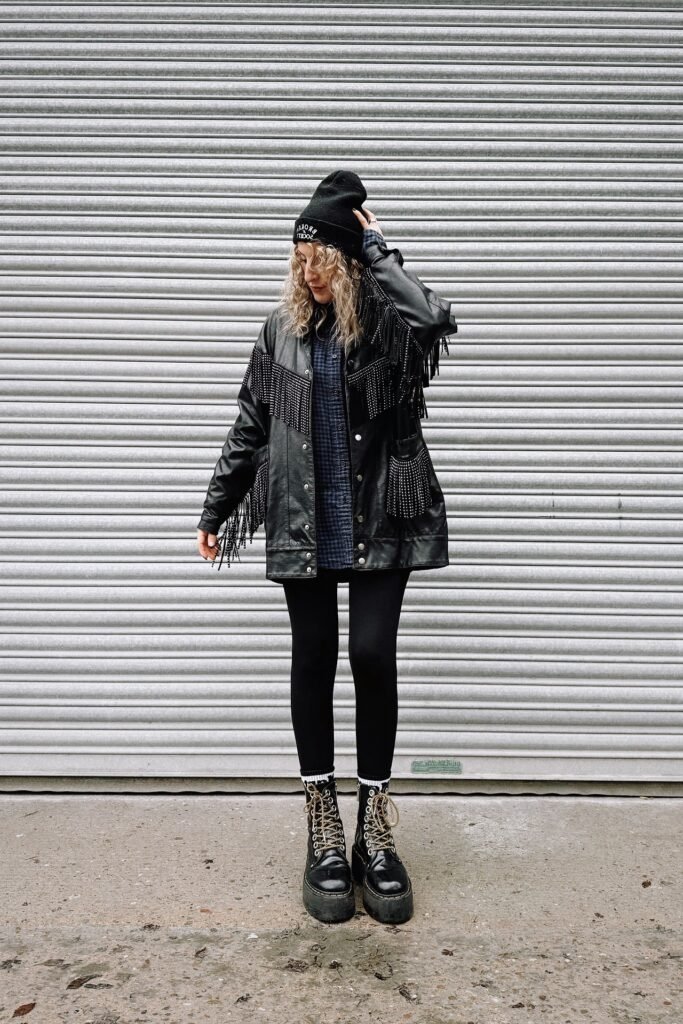 Fringed Leather Jacket + Plaid Button-down + Black Leggings + Platform Lace-up Boots