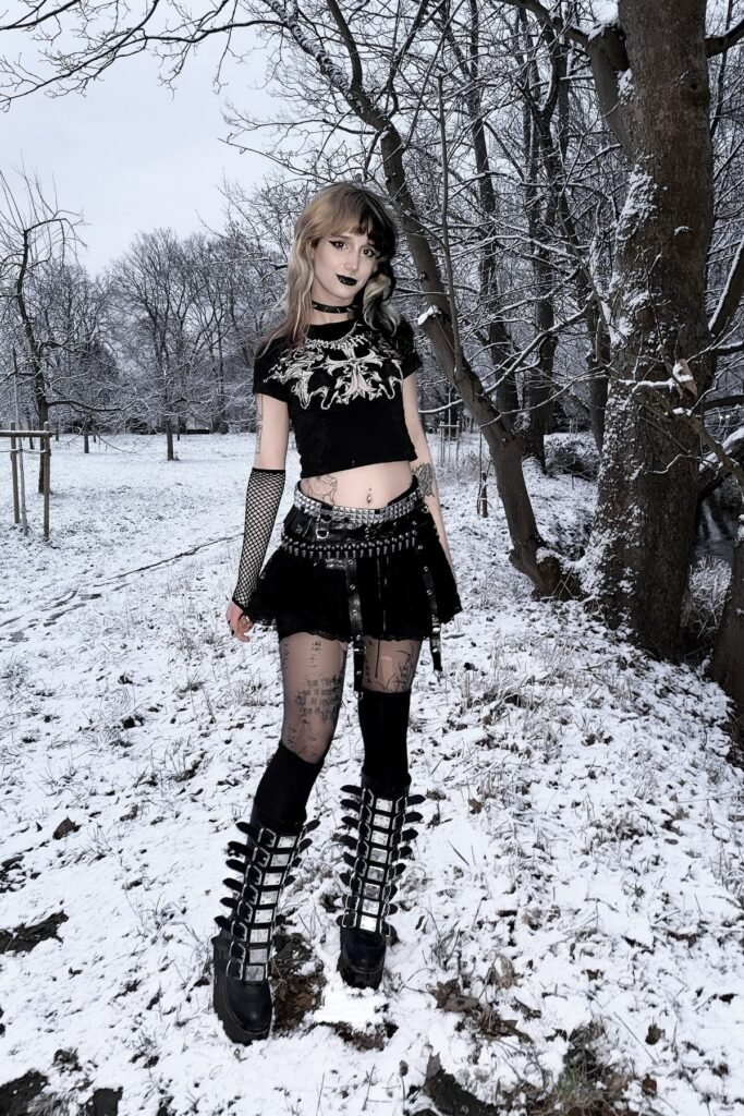 Graphic Crop Top + Black Ruffled Mini Skirt + Knee-High Buckled Platform Boots
