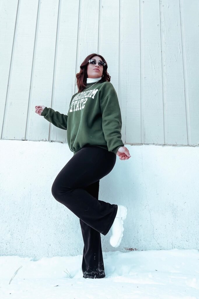 Green Graphic Sweatshirt + Black Flared Trousers + White Chunky Boots