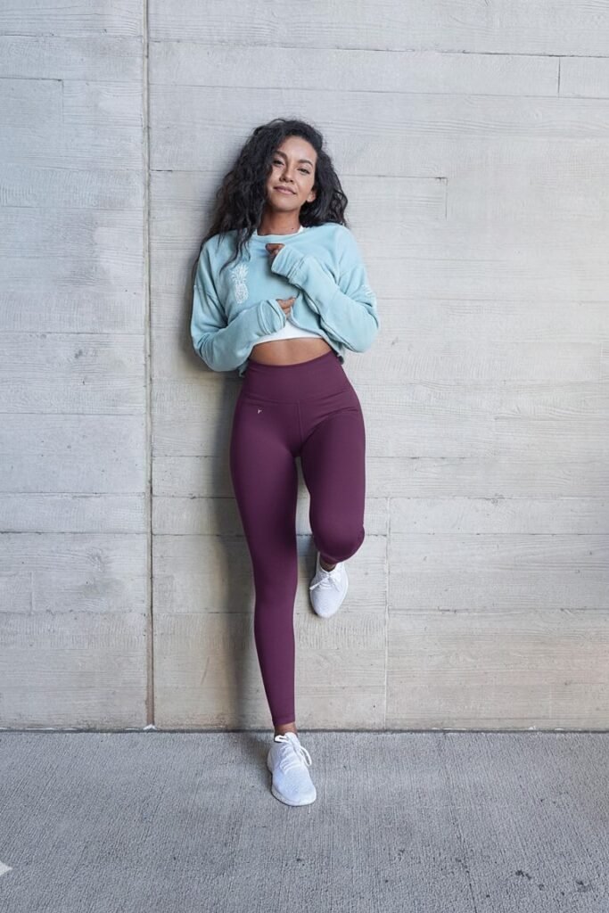 Light Blue Cropped Graphic Sweatshirt + Plum High-Waisted Leggings + White Running Shoes