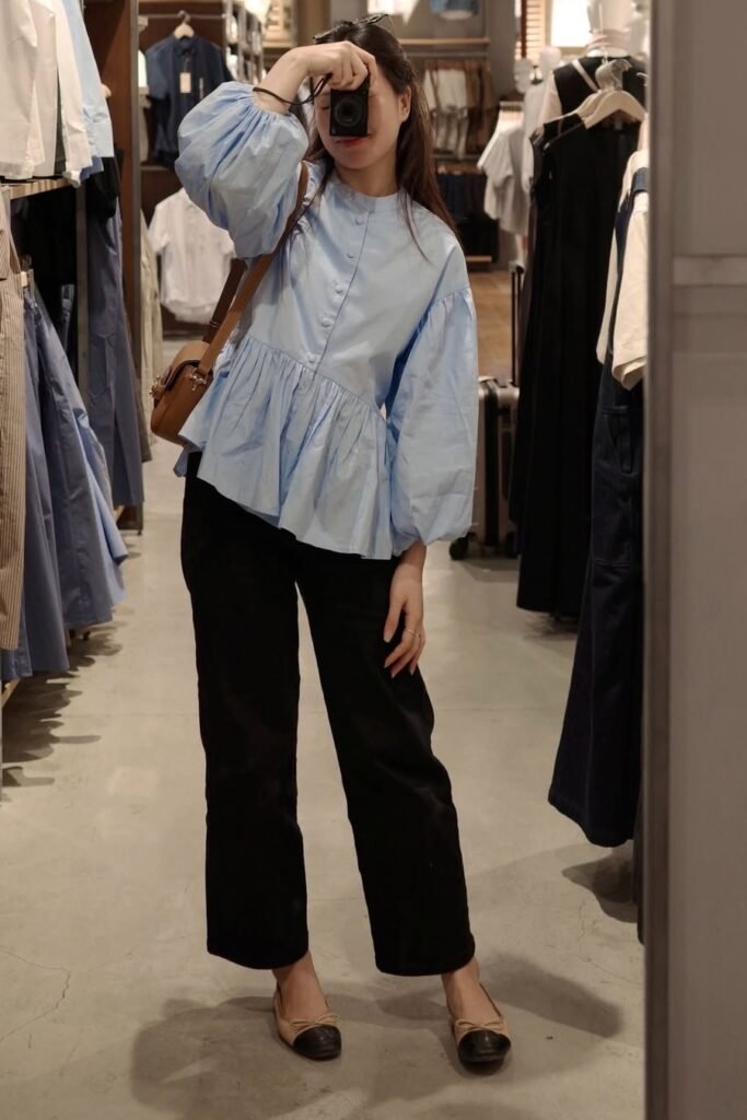 Light Blue Peplum Blouse with Puff Sleeves + Black Straight-Leg Trousers + Tan and Black Cap-Toe Ballet Flats