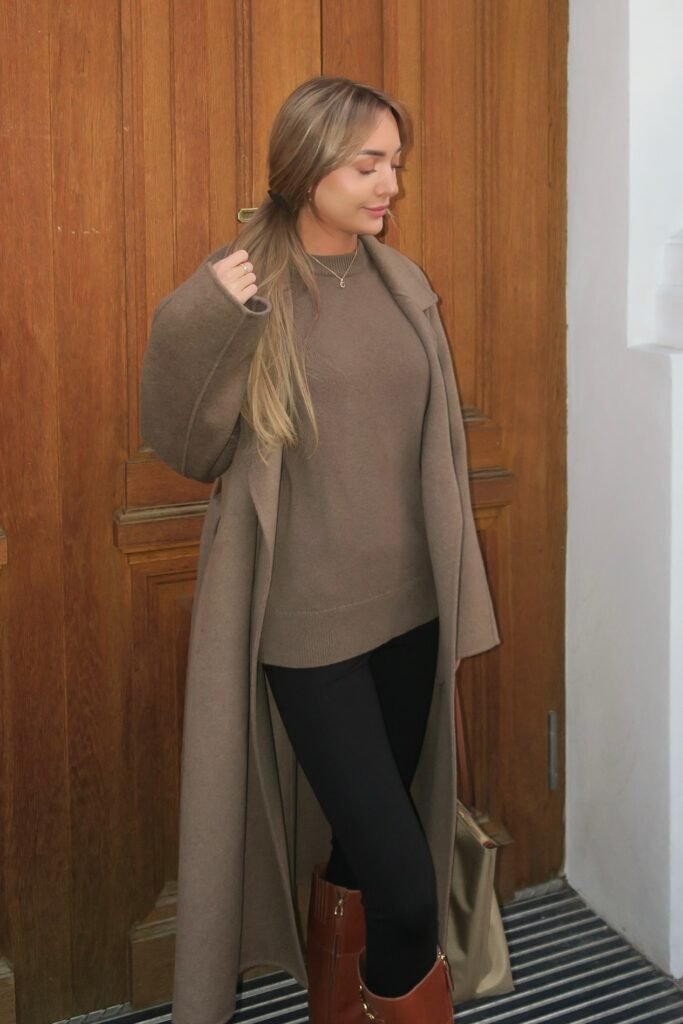 Long Taupe Wool Coat + Matching Taupe Sweater + Black Leggings + Tall Brown Leather Boots