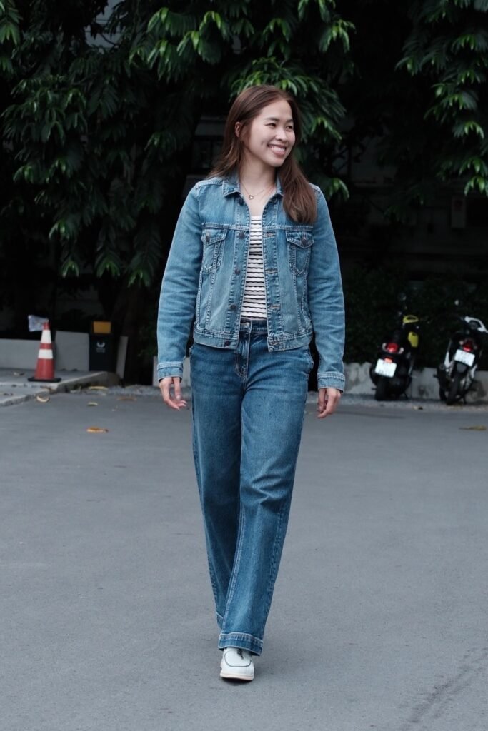Medium Wash Denim Jacket over Striped Tee + Relaxed Fit Wide-Leg Jeans + White Loafers