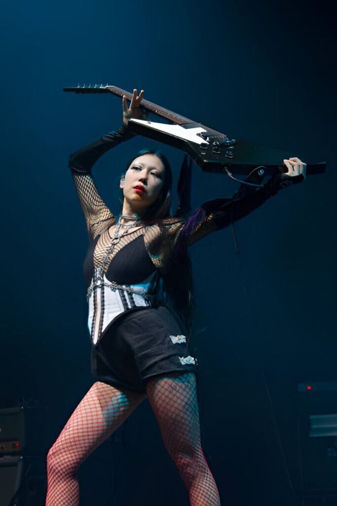 Mesh Long-Sleeve Bodysuit + White Corset Overlay + Red Fishnet Tights