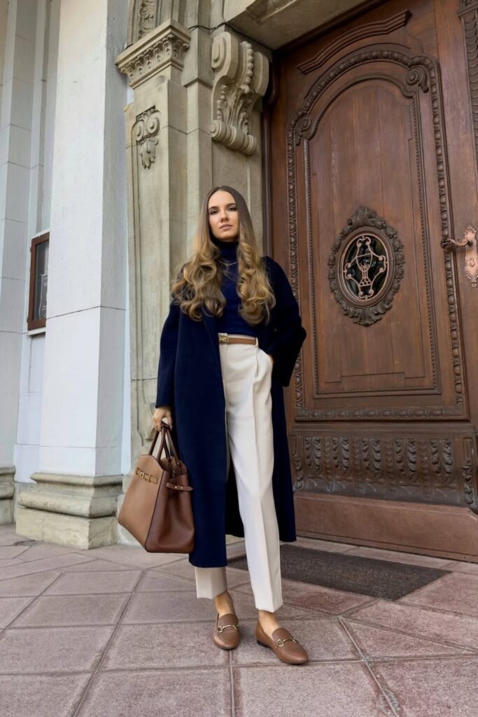 Navy Longline Coat + Cream Tailored Trousers + Brown Leather Horsebit Loafers