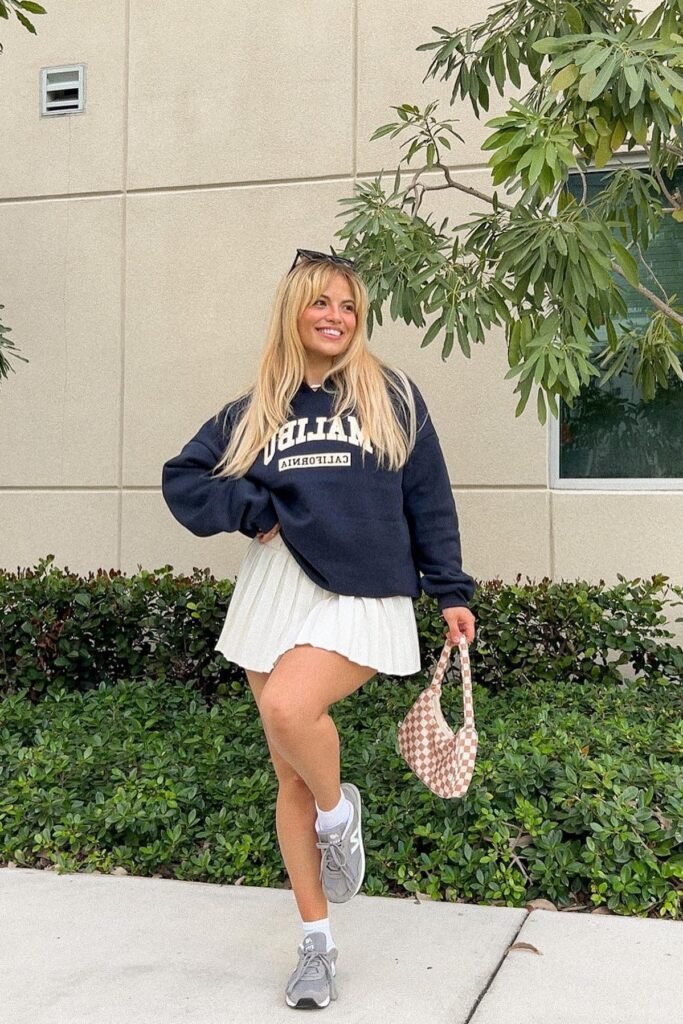 Navy "Malibu" Graphic Hoodie + White Pleated Mini Skirt + Grey New Balance Sneakers