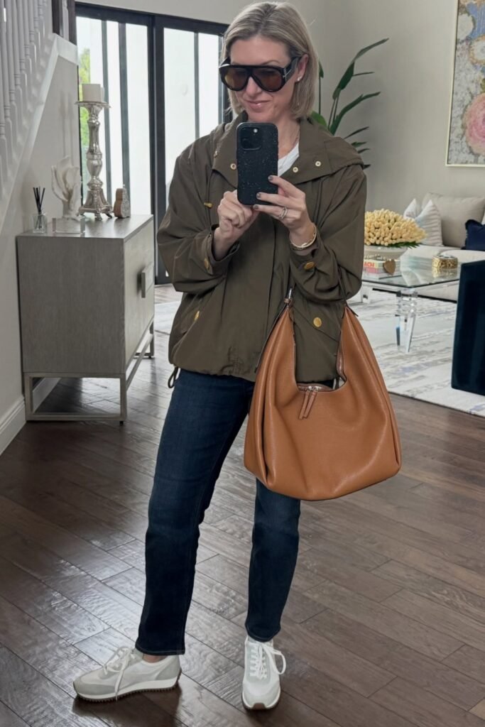 Olive Green Hooded Anorak + Dark Wash Jeans + Tan Leather Slouchy Bag + White Sneakers