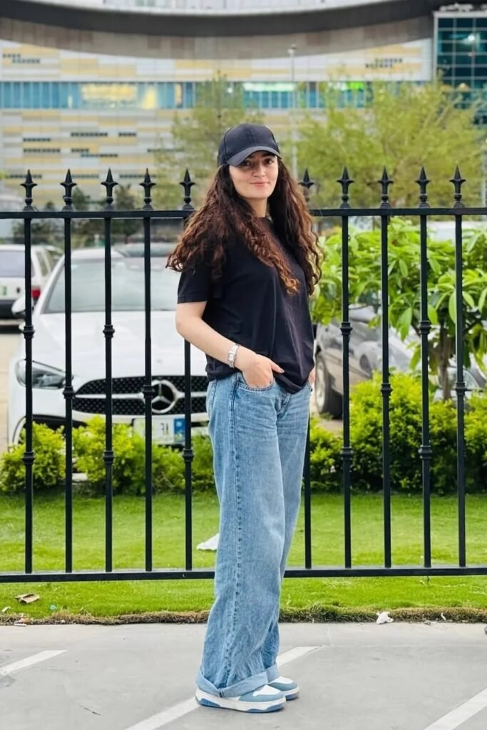 Oversized Black T-Shirt + Light Blue Baggy Jeans + Blue and White Sneakers
