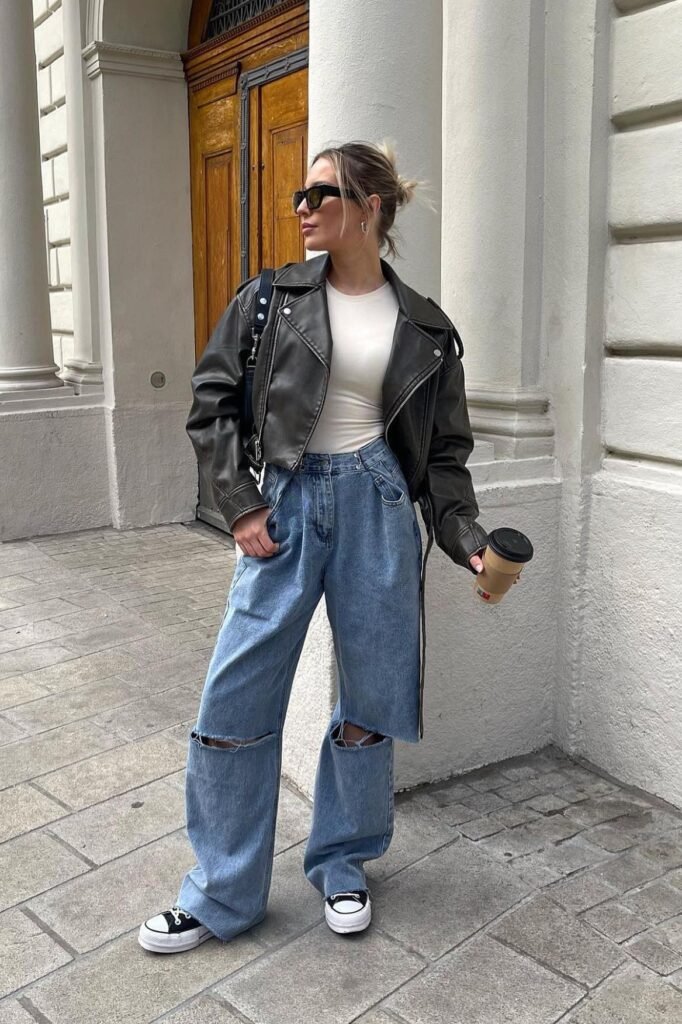 Oversized Dark Brown Leather Jacket + Cream Bodysuit + Ripped Wide-Leg Jeans + Black and White Platform Sneakers