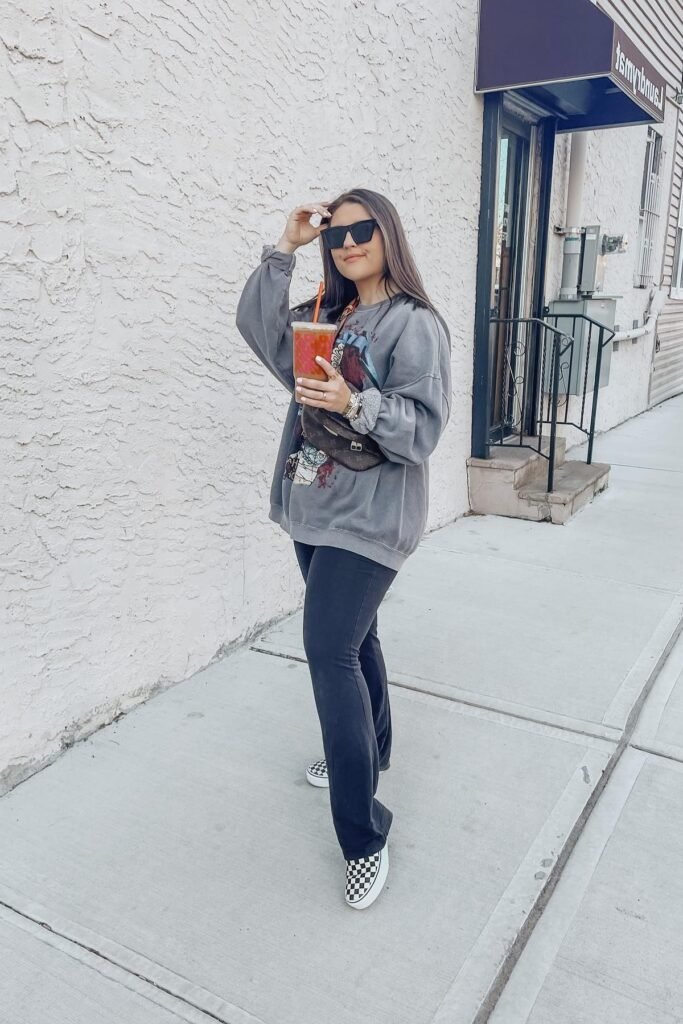 Oversized Graphic Grey Sweatshirt + Navy Flared Jeans + Black and White Checkered Sneakers