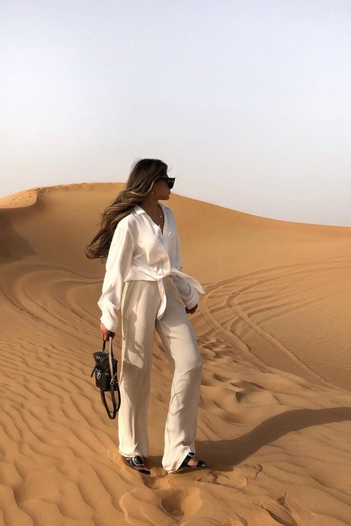 Oversized White Button-Down Shirt + Cream Flowy Wide-Leg Trousers + Black Slide Sandals