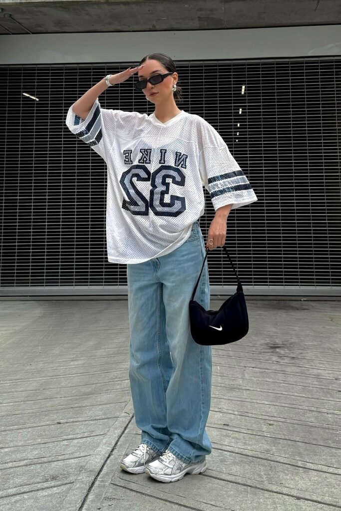 Oversized White Graphic Jersey + Baggy Light Blue Jeans + Silver Sneakers