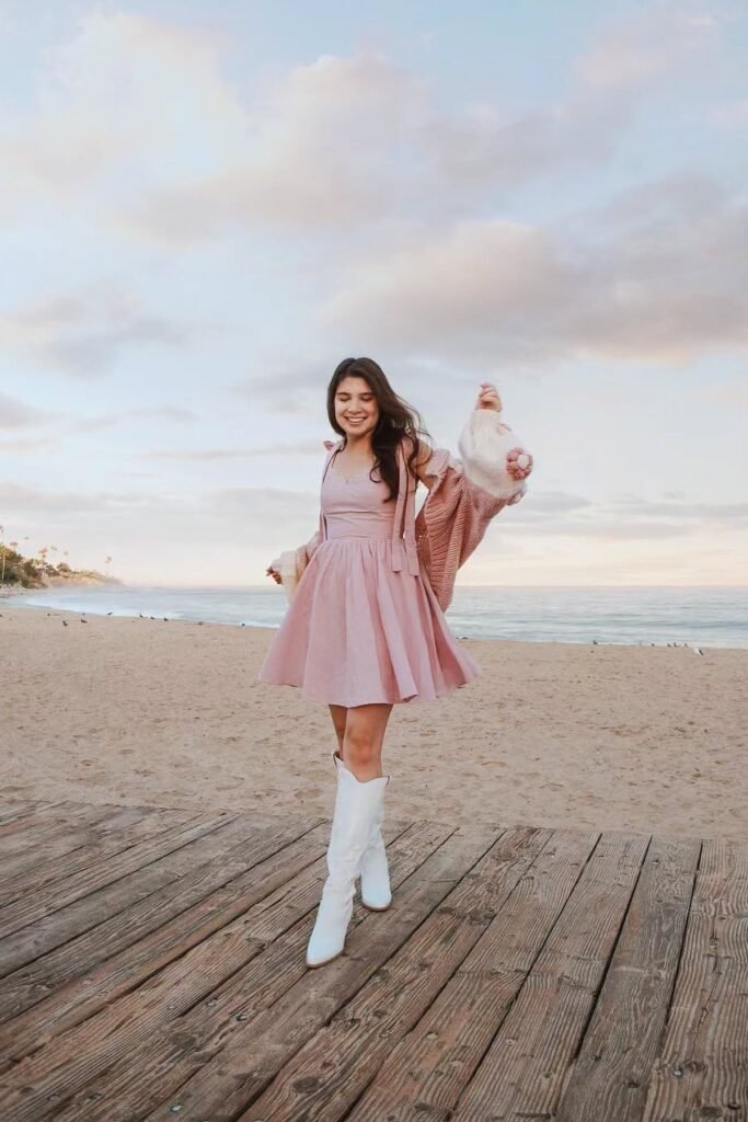 Pink Fit-and-Flare Dress + Oversized Pink Cardigan + White Knee-High Boots
