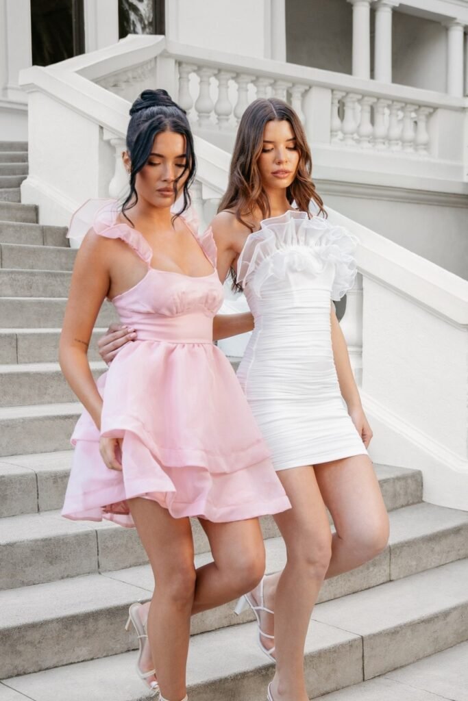 Pink Satin Tiered Mini Dress + White Strappy Heels (Left) / White Ruched Bodycon Mini Dress with Ruffle Trim + White Strappy Heels (Right)