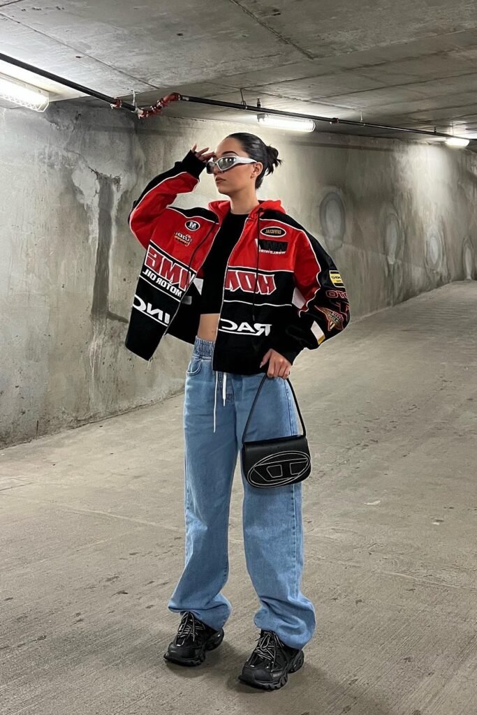 Red and Black Racing Jacket + High-Waisted Blue Jeans + Chunky Black Sneakers