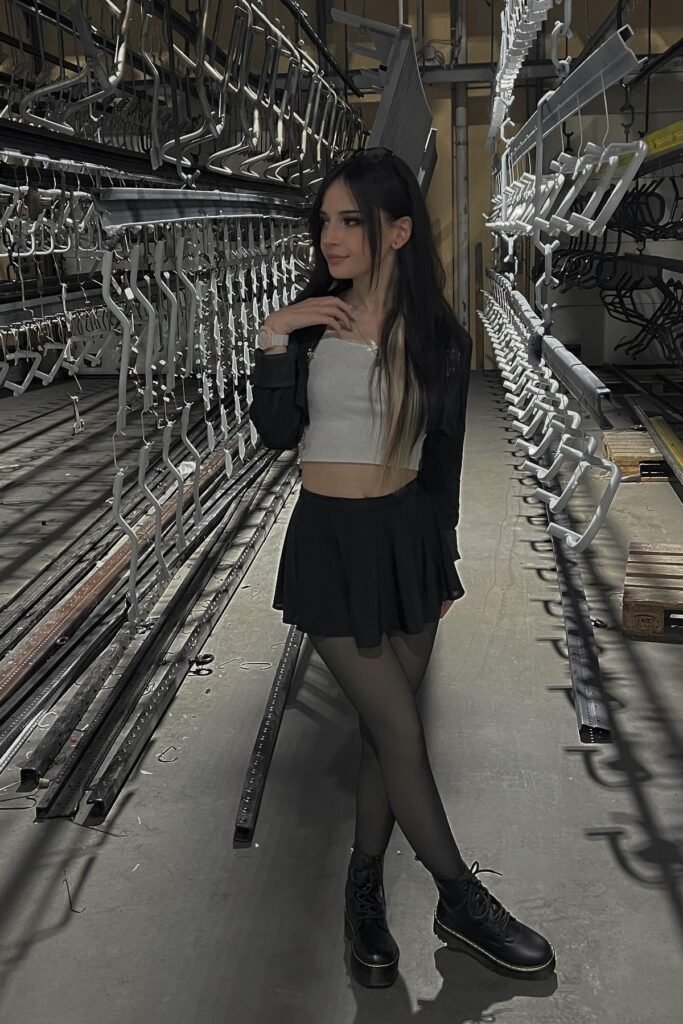 White Crop Top + Black Cropped Jacket + Black Pleated Mini Skirt + Sheer Black Tights + Black Platform Boots