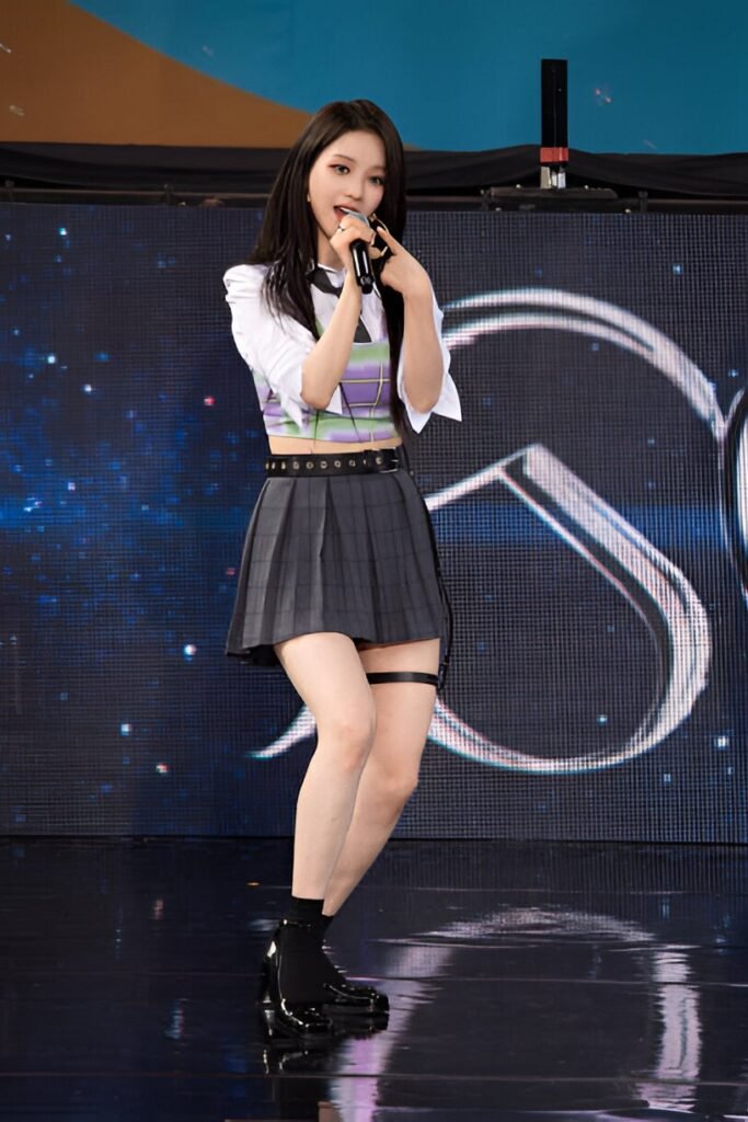 White Cropped Shirt + Plaid Vest + Grey Pleated Skirt + Black Loafers