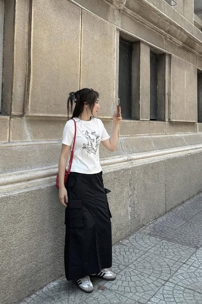 White Graphic T-Shirt + Black Cargo Maxi Skirt + Black and White Athletic Sneakers