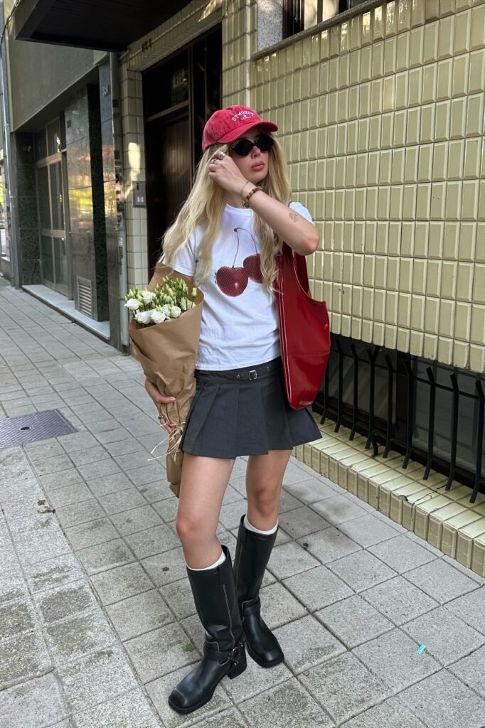 White Graphic T-Shirt + Dark Grey Pleated Mini Skirt + Black Knee-High Boots