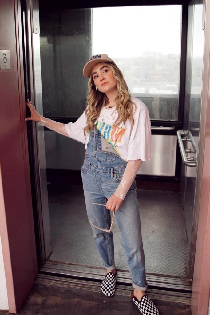 White Graphic T-Shirt + Denim Overalls + White Lace Long-Sleeve Undershirt + Checkerboard Slip-On Shoes