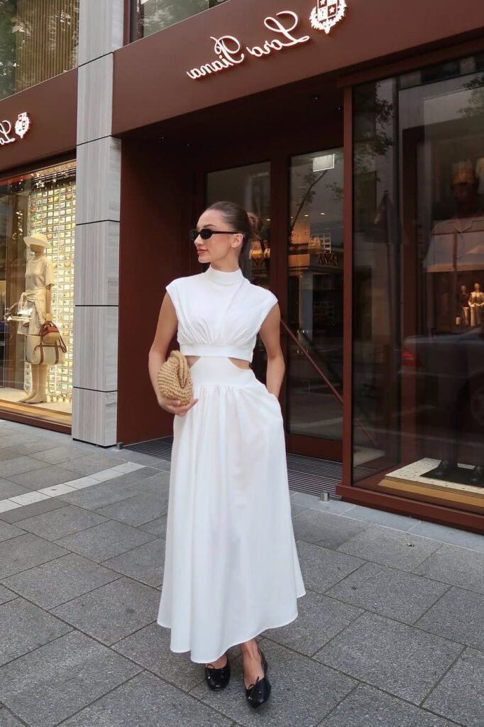 White High-Neck Cutout Maxi Dress + Black Pointed-Toe Flats + Woven Clutch