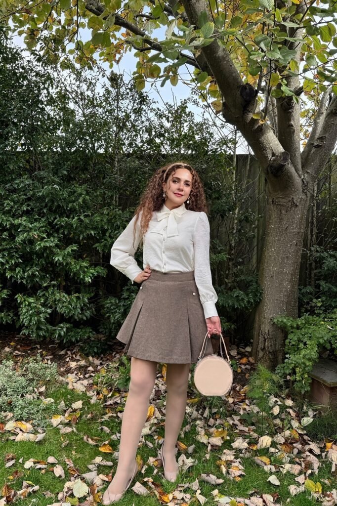 White Long-Sleeve Pussy-Bow Blouse + Brown Pleated Mini Skirt + Nude Pointed-Toe Flats
