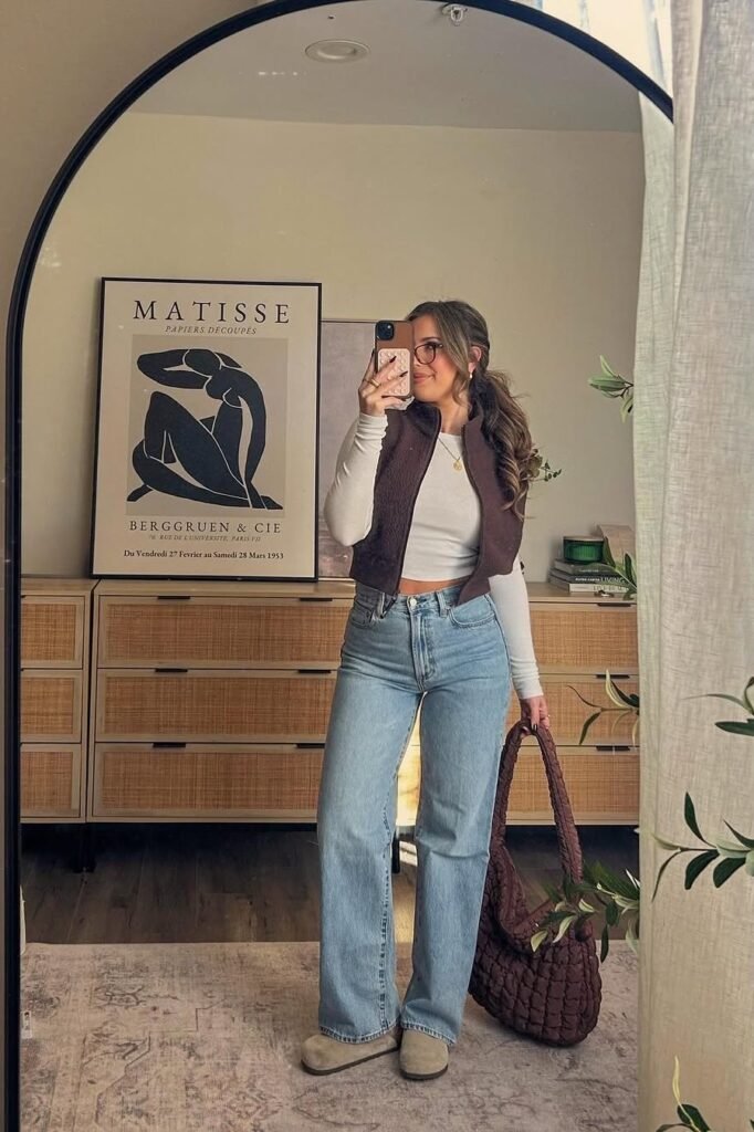 White Long Sleeve Top with Brown Puffer Vest + High-Waisted Blue Jeans + Tan Suede Clogs