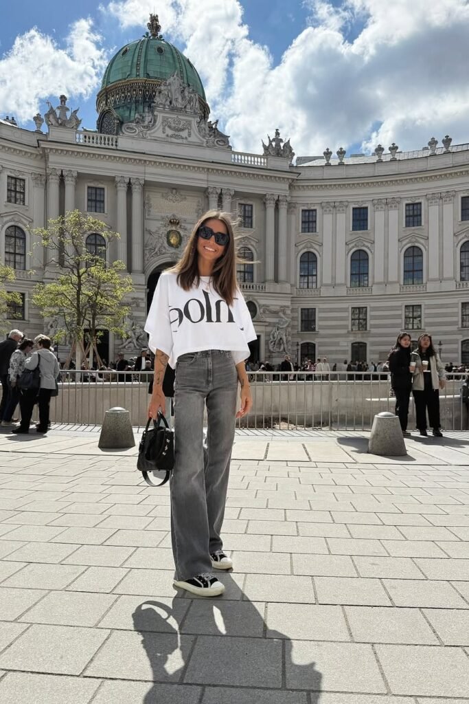 White Oversized Graphic T-Shirt + Grey Wide-Leg Jeans + Black and White Sneakers