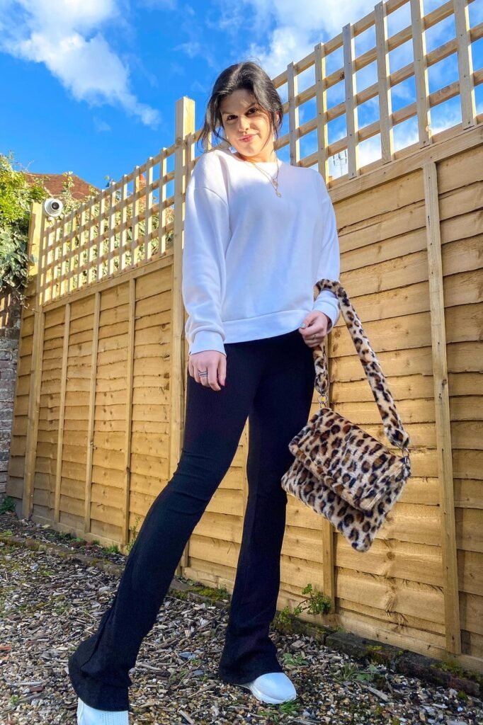 White Oversized Sweatshirt + Black Flared Leggings + Leopard Print Faux Fur Bag + White Sneakers