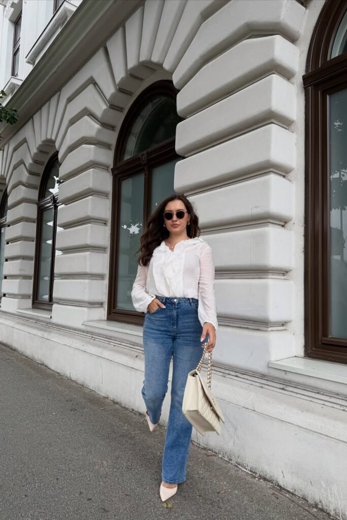 White Ruffled Blouse + Medium Wash Jeans + Beige Pointed-Toe Heels + Beige Quilted Bag