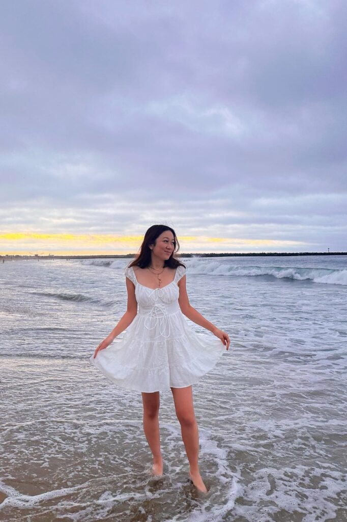 White Ruffled Mini Dress + Lace-Up Bodice + Layered Gold Necklaces