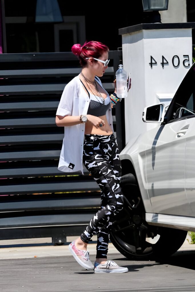 White Short-sleeve Button-up Shirt + Grey Sports Bra + Black and White Camo Leggings + Grey Patterned Slip-on Shoes
