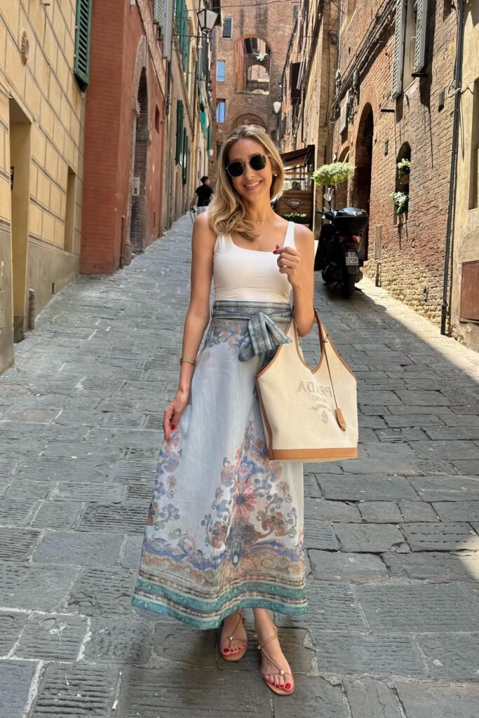 White Tank Top + Blue Patterned Maxi Skirt with Tie Waist + White Canvas Tote Bag + Tan Strappy Sandals