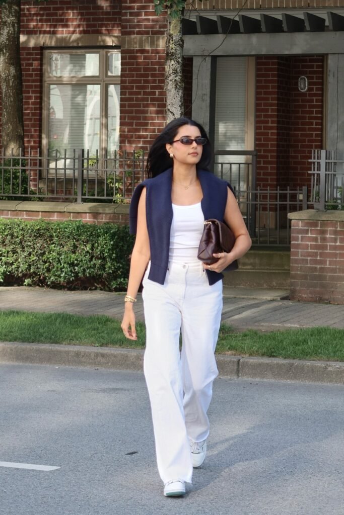 White Tank Top + Navy Shoulder-Draped Sweater + White Wide-Leg Jeans + White Sneakers