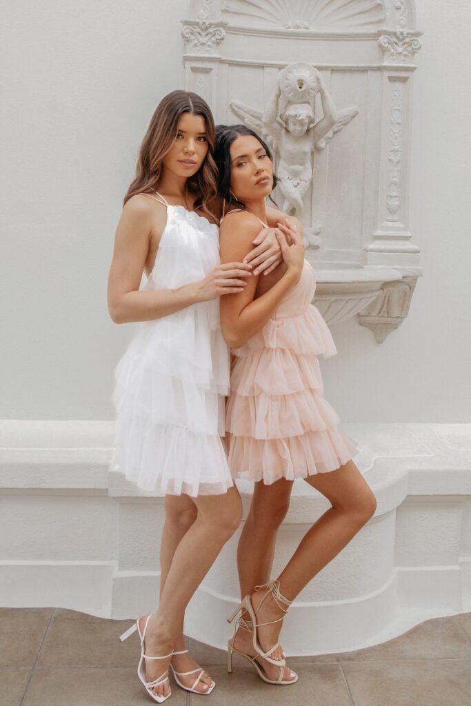 White Tiered Tulle Mini Dress + Nude Strappy Heels (Left) / Light Pink Tiered Tulle Mini Dress + Nude Lace-up Heels (Right)