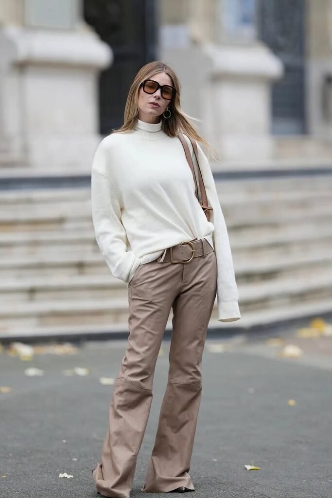 White Turtleneck Sweater + Tan Flared Leather Pants + Brown Belt + Oversized Sunglasses