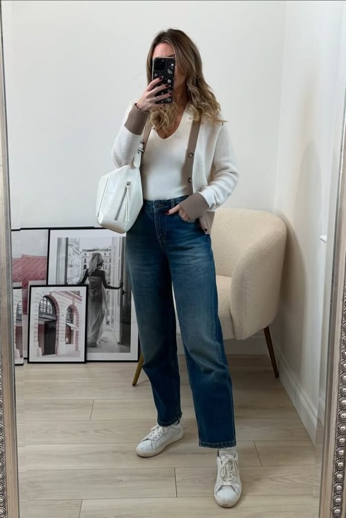 White V-Neck Top + Cream and Tan Cardigan + Dark Wash Straight-Leg Jeans + White Sneakers