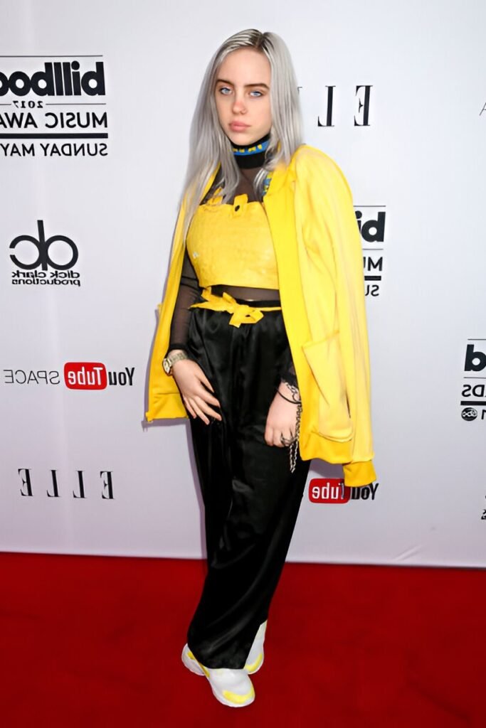 Yellow Windbreaker + Yellow Sequin Crop Top + Black Sheer Mock Neck + Black Satin Trousers + Yellow and White Sneakers