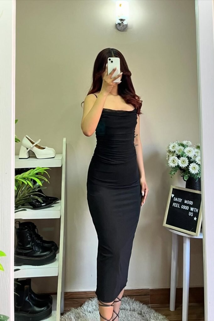 Dramatic and elegant brunch outfit for a day party: a black strapless bodycon maxi dress with lace-up sandals.