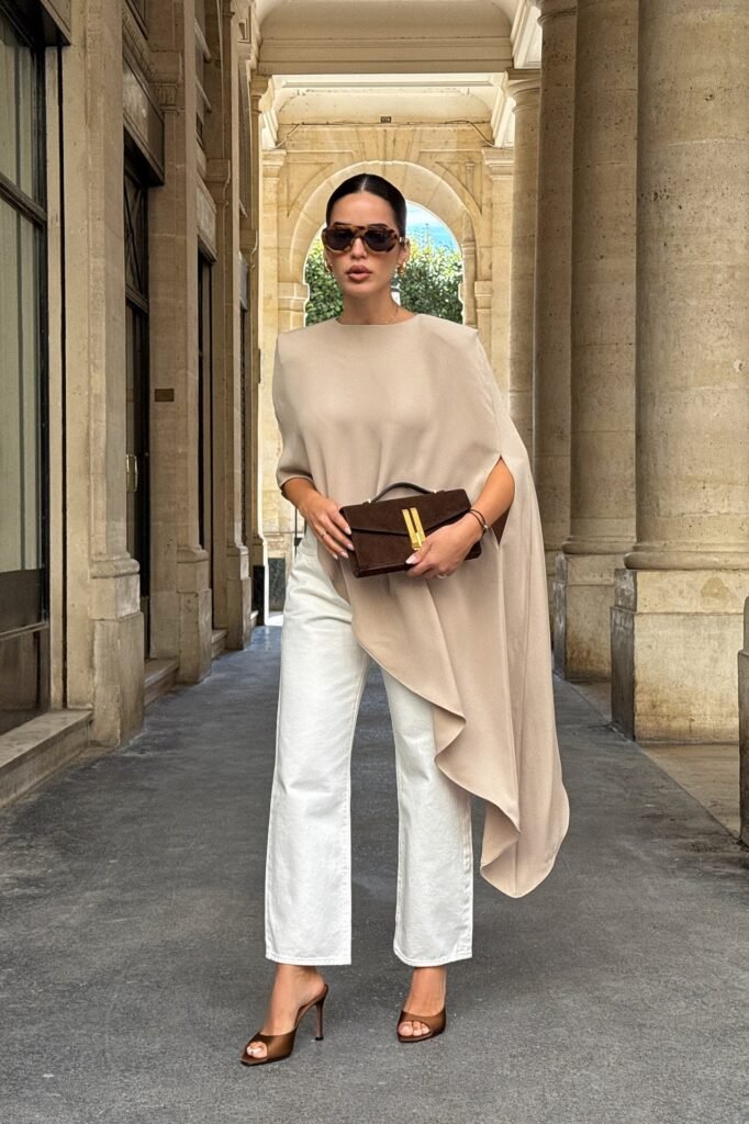 Beige Asymmetrical Cape Top + White Straight-Leg Jeans + Brown Open-Toe Heels