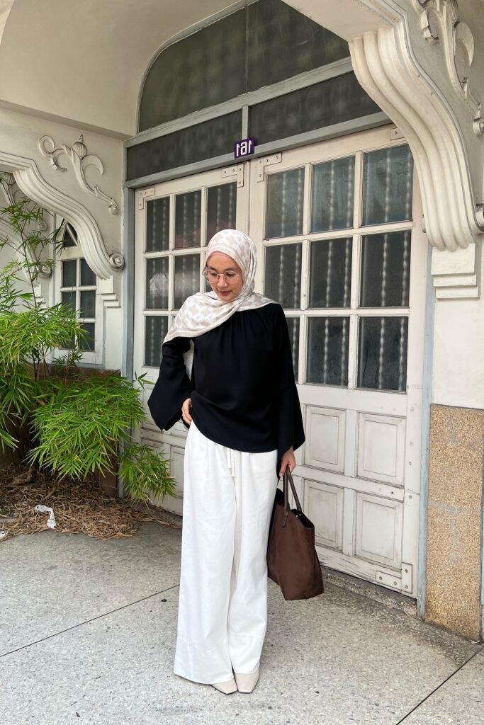 Black Bell-Sleeve Blouse + White Wide-Leg Trousers + Patterned Hijab + Brown Suede Tote