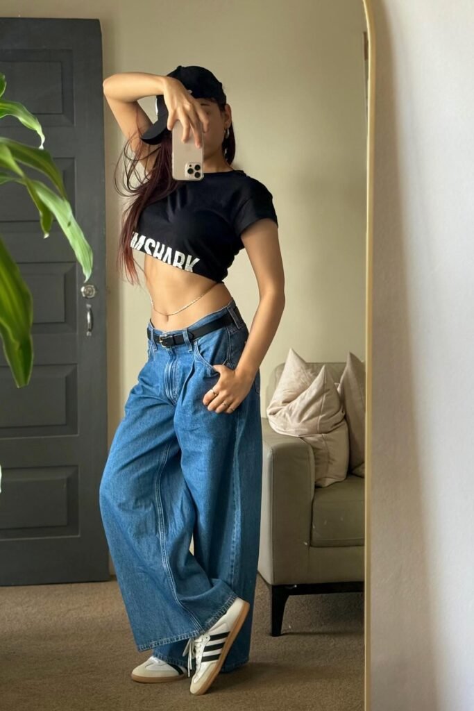 Black Graphic Crop Top + Baggy Blue Jeans + White Samba Sneakers