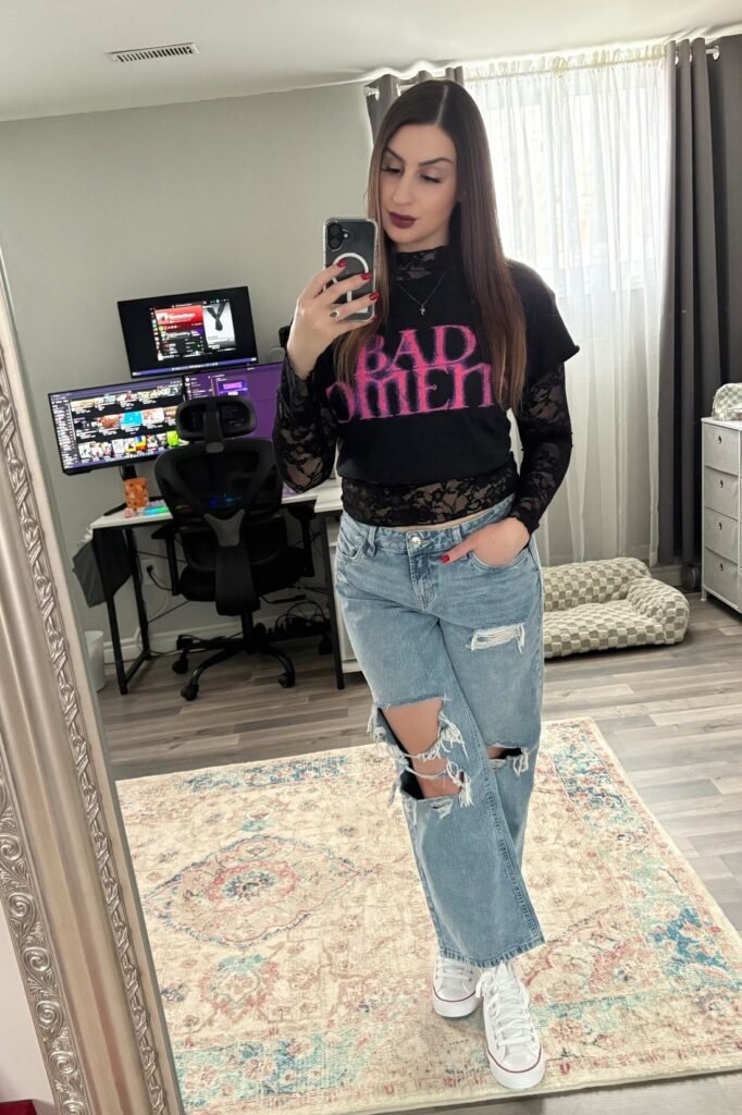 Black Graphic Tee over Lace Long-Sleeve Top + Distressed Light Wash Straight-Leg Jeans + White Sneakers