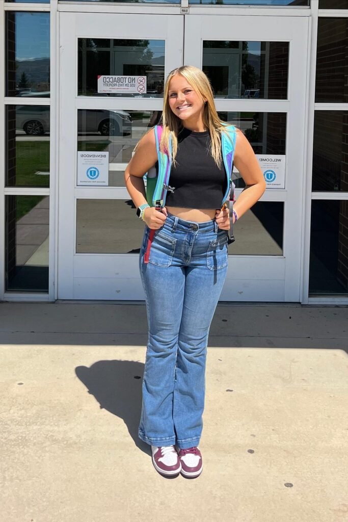 Black High-Neck Crop Tank + Medium Wash Flared Jeans + Maroon and White High-Top Sneakers