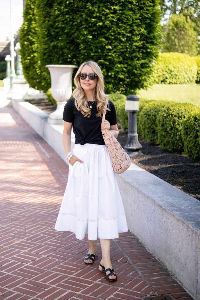 Black Knotted T-Shirt + White A-Line Midi Skirt + Black Slide Sandals