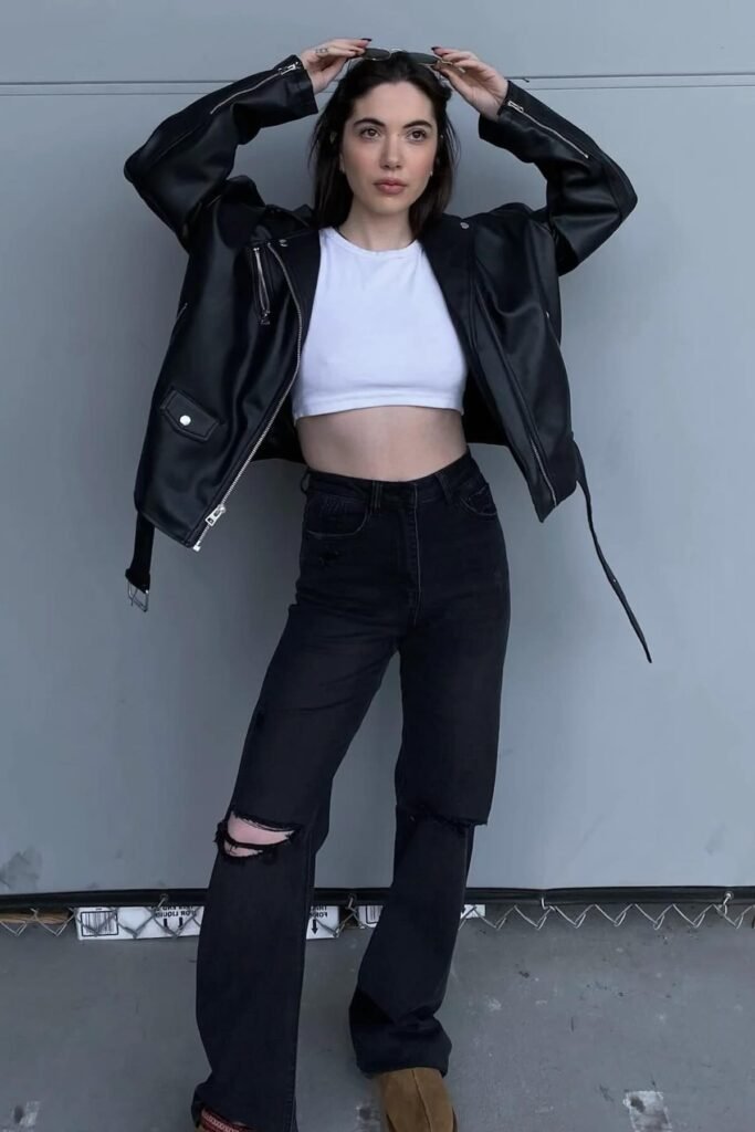 Black Leather Biker Jacket + White Crop Top + Distressed Black Wide-Leg Jeans + Brown Boots